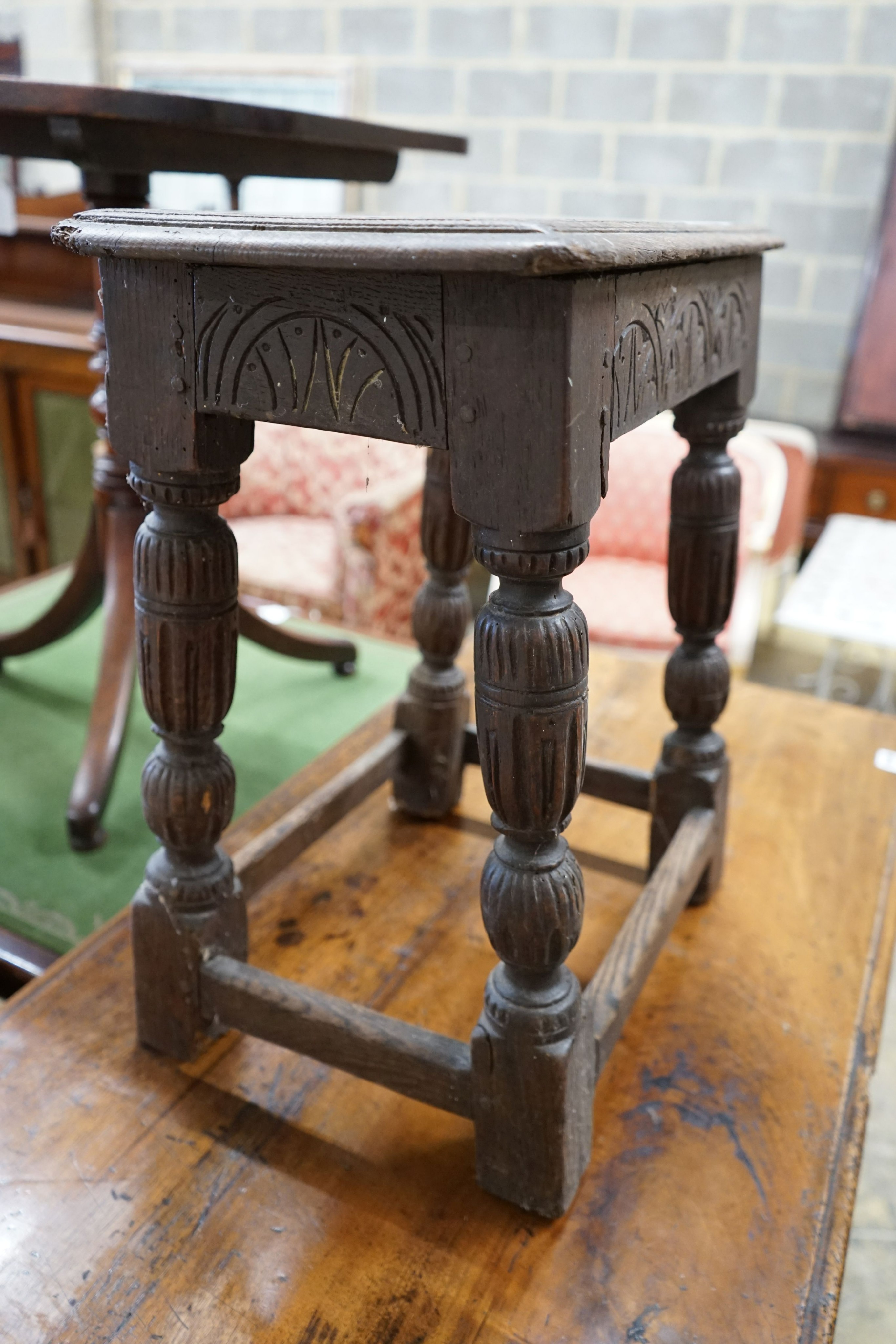 An oak joint stool (wormed), width 45cm, depth 27cm, height 52cm